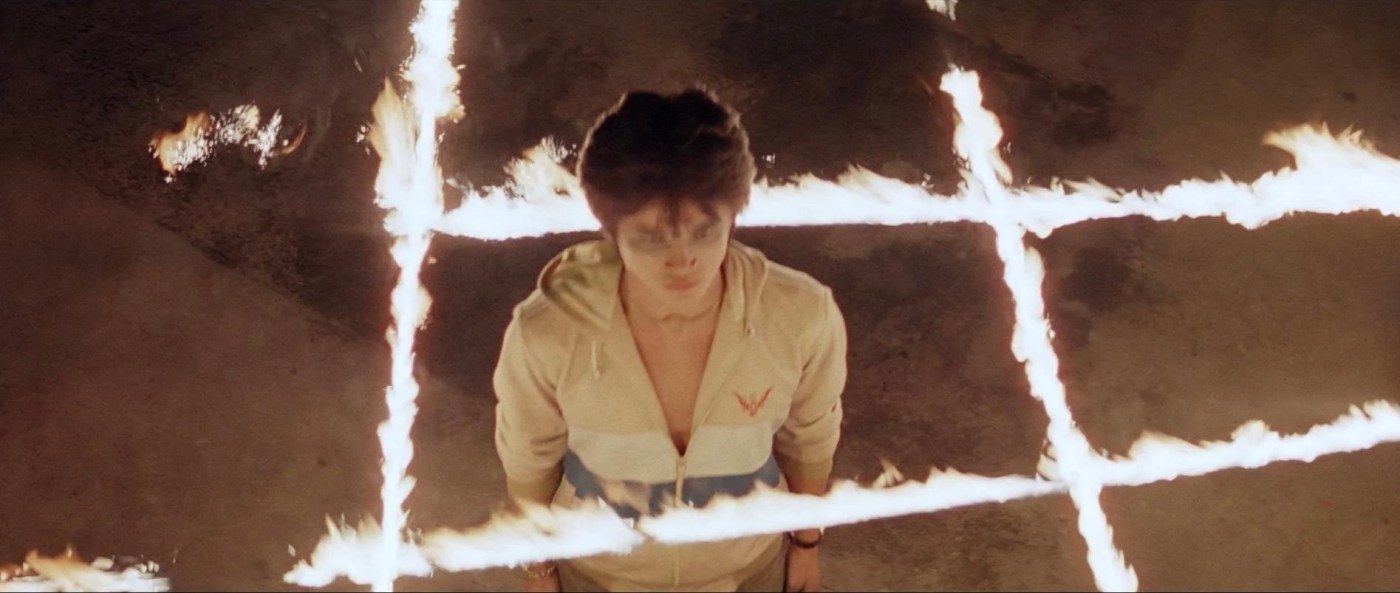 devil fetus header - a young nam stands in the center of a grid of fire
