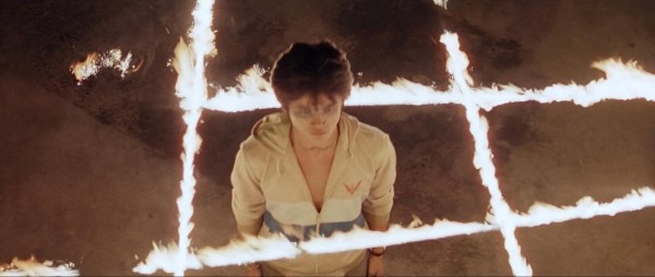 devil fetus header - a young nam stands in the center of a grid of fire